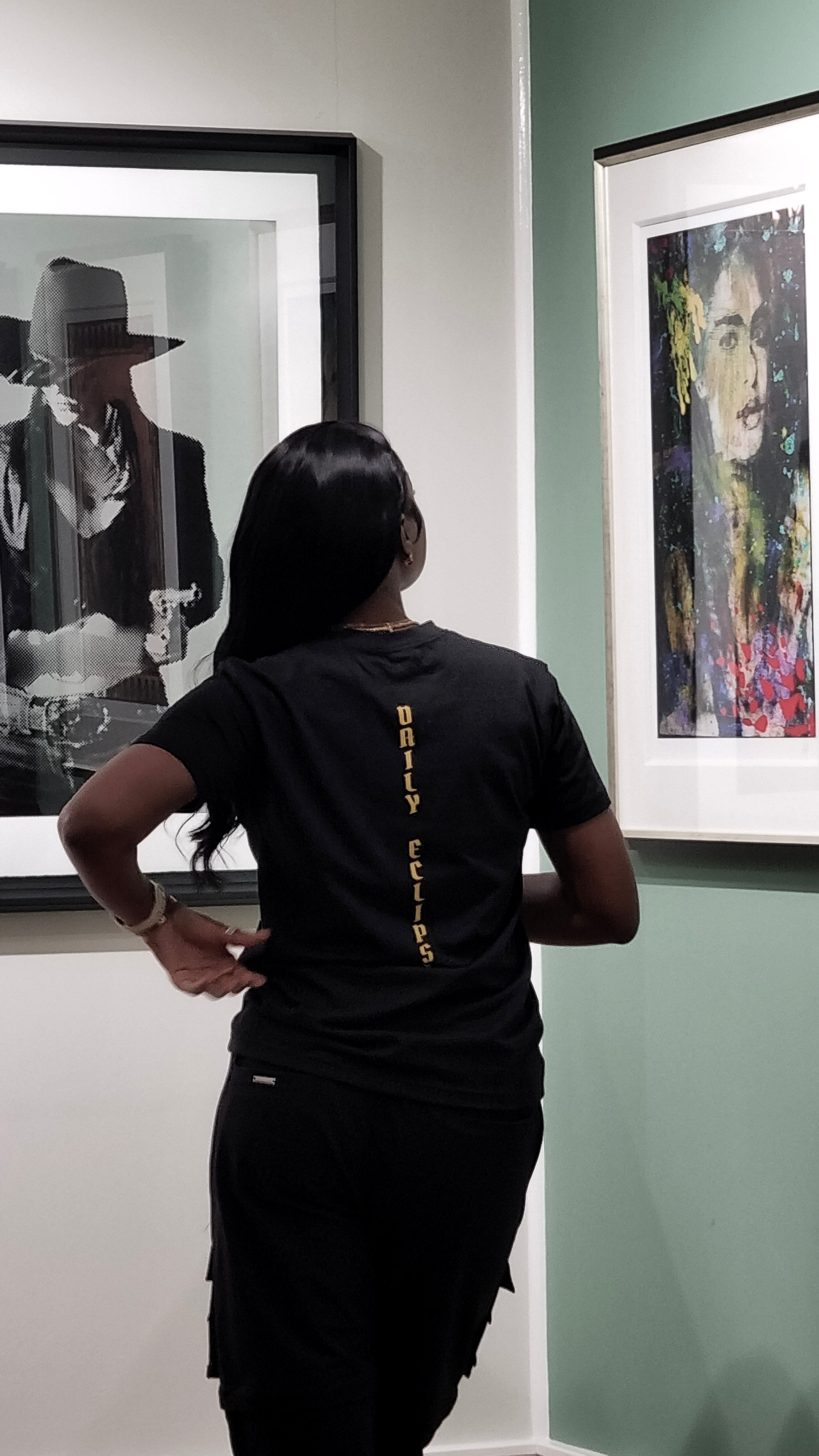 Female model wearing THE ARTSIST t-shirt showing the back